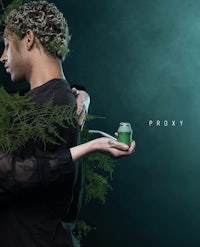 a man and woman holding a jar of greenery