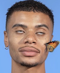 a young man with a butterfly on his face