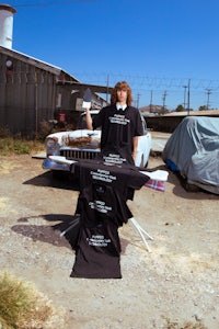 a man standing in front of a car